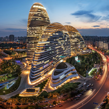 Image of office buildings lit up in evening